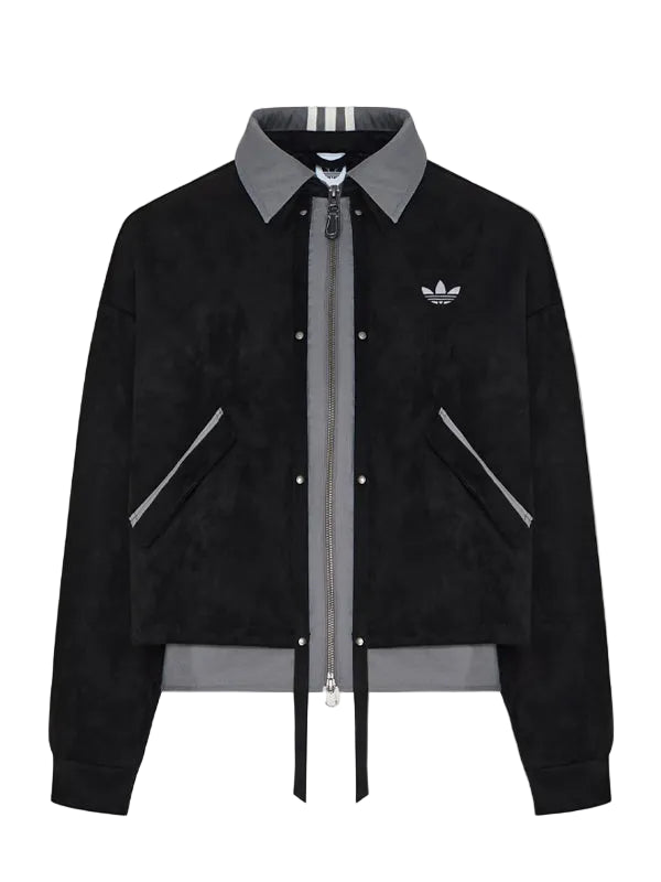 A black suede bomber jacket with a gray collar, zipper, and hem, featuring the Adidas trefoil logo on the chest, displayed on a neutral light gray background.