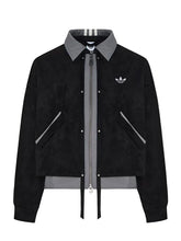 A black suede bomber jacket with a gray collar, zipper, and hem, featuring the Adidas trefoil logo on the chest, displayed on a neutral light gray background.