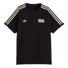 A black short-sleeve t-shirt with three cream stripes on the sleeves, featuring a white Adidas Trefoil logo on the left chest and a white 'oasis' patch on the right chest, shown against a light gray background.