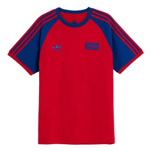 A red and blue raglan t-shirt with three stripes on the sleeves, featuring a blue Adidas trefoil logo on the left chest and a blue 'PUMA' patch on the right chest, shown against a light gray background.