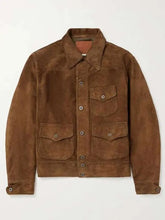 A brown suede utility jacket with a button-up front, collar, and four front flap pockets, shown flat against a light off-white background.