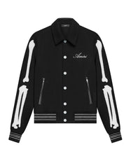 Black jacket with white skeleton designs and 'Amiri' branding on a white background