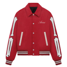 A red varsity-style jacket with white embroidered bone graphics on the sleeves, silver-tone snap buttons, zippered pockets, and white script embroidery reading 'Améri' on the left chest, shown on a light gray background.