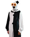 A person wearing a creepy clown costume in a retail store. The costume features a black and white split dress with black pom-poms, a white hood with a black topknot, and oversized orange flower-shaped glasses.