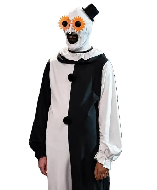 A person wearing a creepy clown costume in a retail store. The costume features a black and white split dress with black pom-poms, a white hood with a black topknot, and oversized orange flower-shaped glasses.