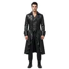 A man modeling a long black faux-leather gothic-style coat over a black vest, black shirt, black trousers, and black boots, standing against a light gray studio background.