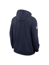 A navy blue hooded sweatshirt shown from the back, featuring a small NFL shield logo on the left sleeve, set against a plain white background.