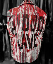 A sleeveless studded vest with a white base covered in dramatic red blood-splatter graphics and large black graphic lettering on the back, shown against a dark blurred background.