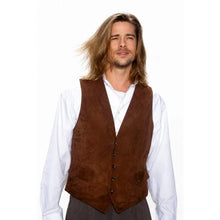 A man with long blonde hair wearing a brown suede vest over a white long-sleeve shirt, photographed against a plain white background.