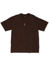 A dark brown short-sleeve t-shirt with a small beige graphic on the left chest, displayed flat against a light gray background.