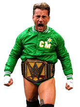 A man in a bright green bomber jacket with 'CM' and a star logo, wearing a WWE championship belt and white wrist wraps, standing against a black background with his mouth open in a shouting pose.