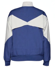 A colorblock track jacket shown from the back, featuring a royal blue body with contrasting white shoulder and collar panels.