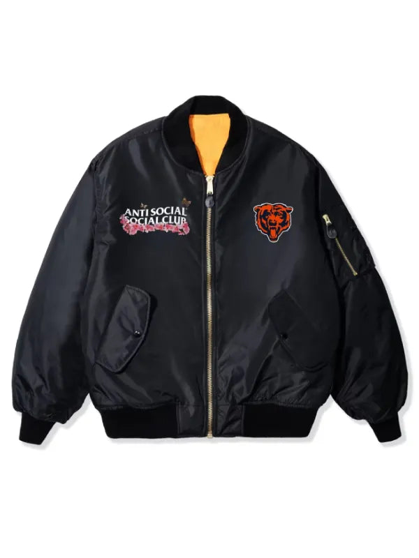 A black nylon bomber jacket with a gold zipper, featuring the 'Anti Social Social Club' logo on the left chest and a Chicago Bears bear head logo on the right chest, displayed on a clean white background.