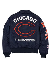 Back view of a navy blue New Era Chicago Bears bomber jacket with 'CHICAGO' and the team logo in orange and white, and 'New Era' printed in white below.