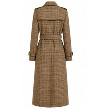 A long brown trench coat with a subtle plaid pattern, featuring a belted waist and shoulder epaulets, shown from the back on a plain white background.