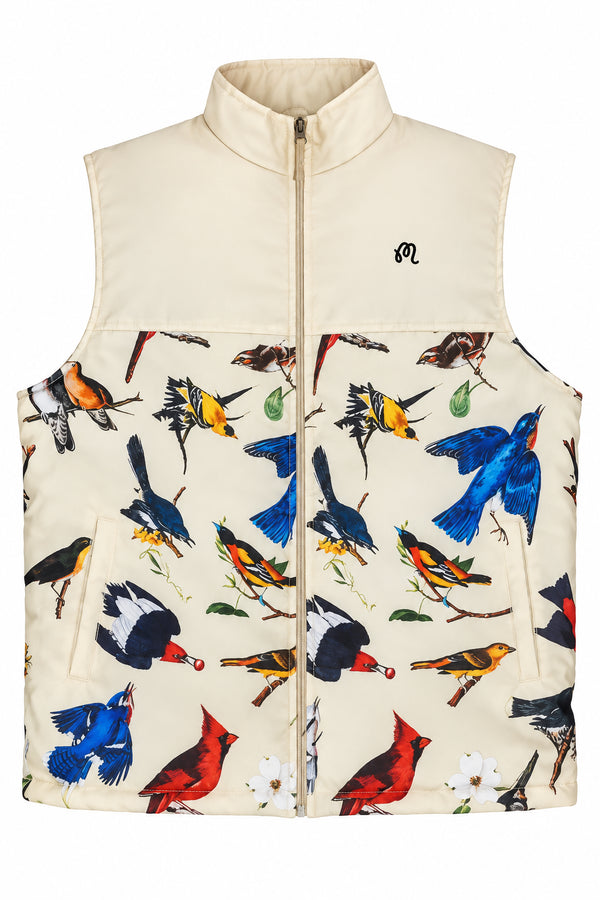 A sleeveless zip-front vest in warm beige with an allover colorful bird print across the lower half and upper front. The vest has a stand collar, front zipper, and a small black embroidered logo on the left chest.