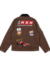 A brown jacket shown from the back, featuring a large 'RSN RACING SPORTS NETWORK' graphic with a checkered flag and a red race car, along with several racing-themed patches on the back and sleeves.