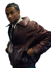 Burgundy bomber-style jacket with front zipper closure