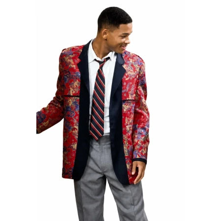 A man wearing a red and blue patterned blazer with dark navy lapels, a white dress shirt, a red and navy striped tie, and gray trousers, shown against a plain white background.