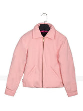 A light pink zip-up jacket with a stand collar, displayed on a black hanger against a plain white background.