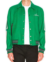 A bright green varsity-style jacket with white sleeve stripes, striped ribbed cuffs and hem, and a white t-shirt underneath, worn by a model.