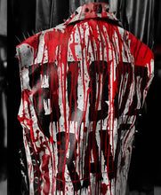 A sleeveless black vest with a matching cap, covered in dramatic red blood splatter and dripping paint effects, set against a dark background.