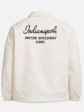 An off-white coach jacket shown from the back, featuring 'Indianapolis Motor Speedway Corp.' printed in black across the upper back.