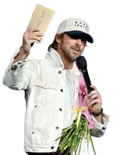 Man holding a microphone and bouquet of flowers with a blue background