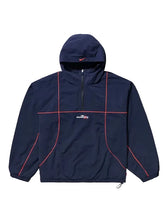 A navy blue hooded windbreaker jacket with red piping details and a white 'streetfly' logo on the chest, displayed against a solid light gray background.