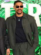 Aaron Pierre grey jacket with zipper closure and buttoned cuffs