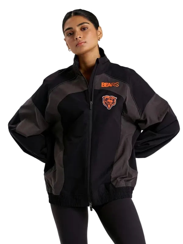 A woman modeling a black and dark gray Chicago Bears zip-up jacket against a solid gray background.