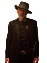 A man wearing a dark western-style outfit with a wide-brimmed hat, black suit jacket and vest, black pants, and a holster, isolated on a white background.