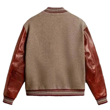 A classic varsity-style jacket shown from the back, featuring a heathered taupe-brown wool body and glossy reddish-brown leather sleeves, finished with striped ribbed collar, cuffs, and hem.