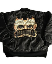 A black satin bomber jacket featuring a large graphic print on the back with Michael Jackson's eyes, a gold masquerade mask, and the text 'Michael Jackson' and 'Dangerous World Tour'.