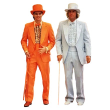 Two men standing indoors wearing formal suits. The man on the left wears a bright orange three-piece suit with a matching orange hat and bow tie.