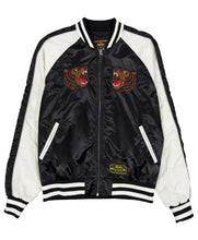 A black and white satin bomber jacket featuring embroidered roaring bear patches on the chest, a gold-tone zipper, and a 'SOUTH CAROLINA' brand patch near the hem.