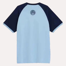 A short-sleeve raglan t-shirt with a light blue body and dark navy sleeves, featuring a circular graphic print on the upper chest.