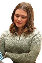 A woman with shoulder-length brown hair wearing a sage green and white argyle knit polo sweater, looking down with a neutral expression.