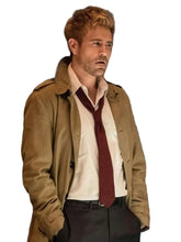 Tan trench coat with flap side pockets and buckle cuffs