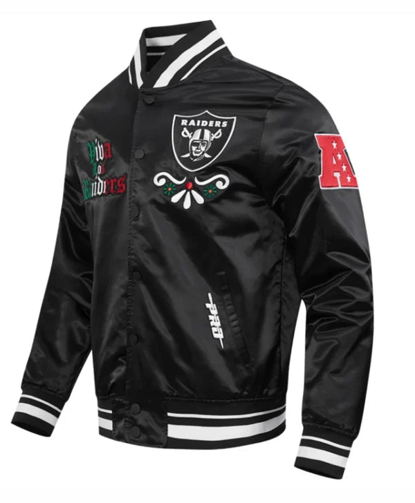 A black satin bomber jacket featuring Oakland Raiders patches, including the Raiders logo on the chest, a 'Raiders vs. Cowboys' patch on the right sleeve, and a red 'A' patch on the left sleeve, shown against a plain white background.