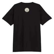 A black short-sleeve t-shirt shown from the back, featuring a circular metallic silver graphic printed on the upper back, set against a plain off-white background.