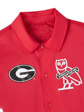 A close-up of a red button-front collared shirt jacket featuring a black-and-white Georgia 'G' logo on the left chest and a white owl graphic with 'October's Very Own' text on the right chest, shown against a light gray background.