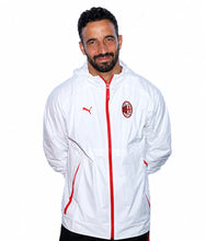 A man wearing a white Puma hooded windbreaker jacket with red accents and the AC Milan club crest on the chest, photographed against a plain white background.