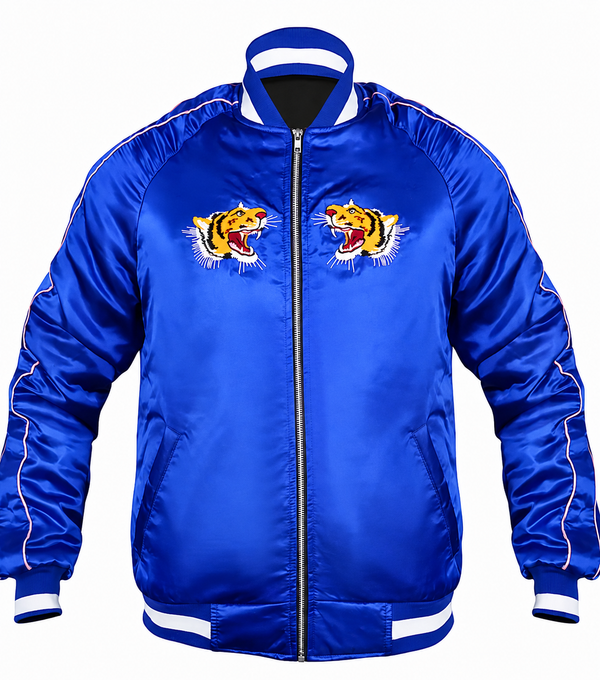 A royal blue satin bomber jacket with white contrast stitching, a black front zipper, and two embroidered tiger graphics on the chest, displayed on a solid white background.