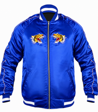 A royal blue satin bomber jacket with white contrast stitching, a black front zipper, and two embroidered tiger graphics on the chest, displayed on a solid white background.