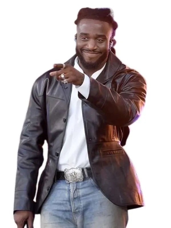 A man wearing a dark brown leather blazer over a white shirt and light blue jeans, pointing forward against a plain white background.