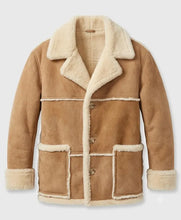 A tan suede shearling jacket with a cream-colored plush lining, featuring a wide collar, button closure, and front patch pockets, shown against a light gray background.