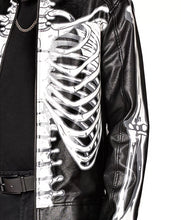 Black faux leather jacket featuring a large white skeleton rib cage graphic on the front, styled over a black shirt and belt.