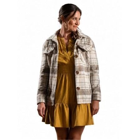 A woman modeling a brown and beige plaid button-up jacket over a mustard yellow dress, photographed against a solid white background.