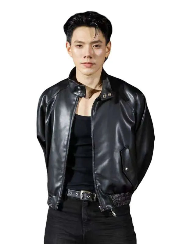 A man wearing a black leather jacket over a black tank top and black pants, photographed against a plain white background.